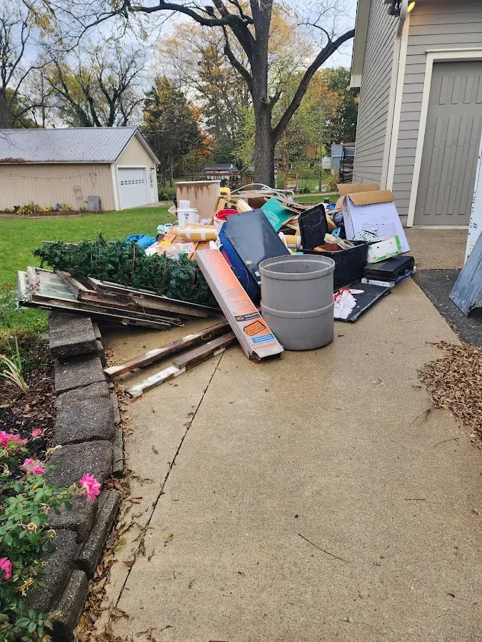 Dumpster being loaded with debris for Commercial Dumpster Rental in Woodmore
